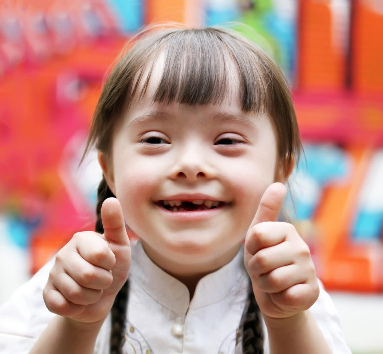 Portrait of beautiful happy girl giving thumbs up.